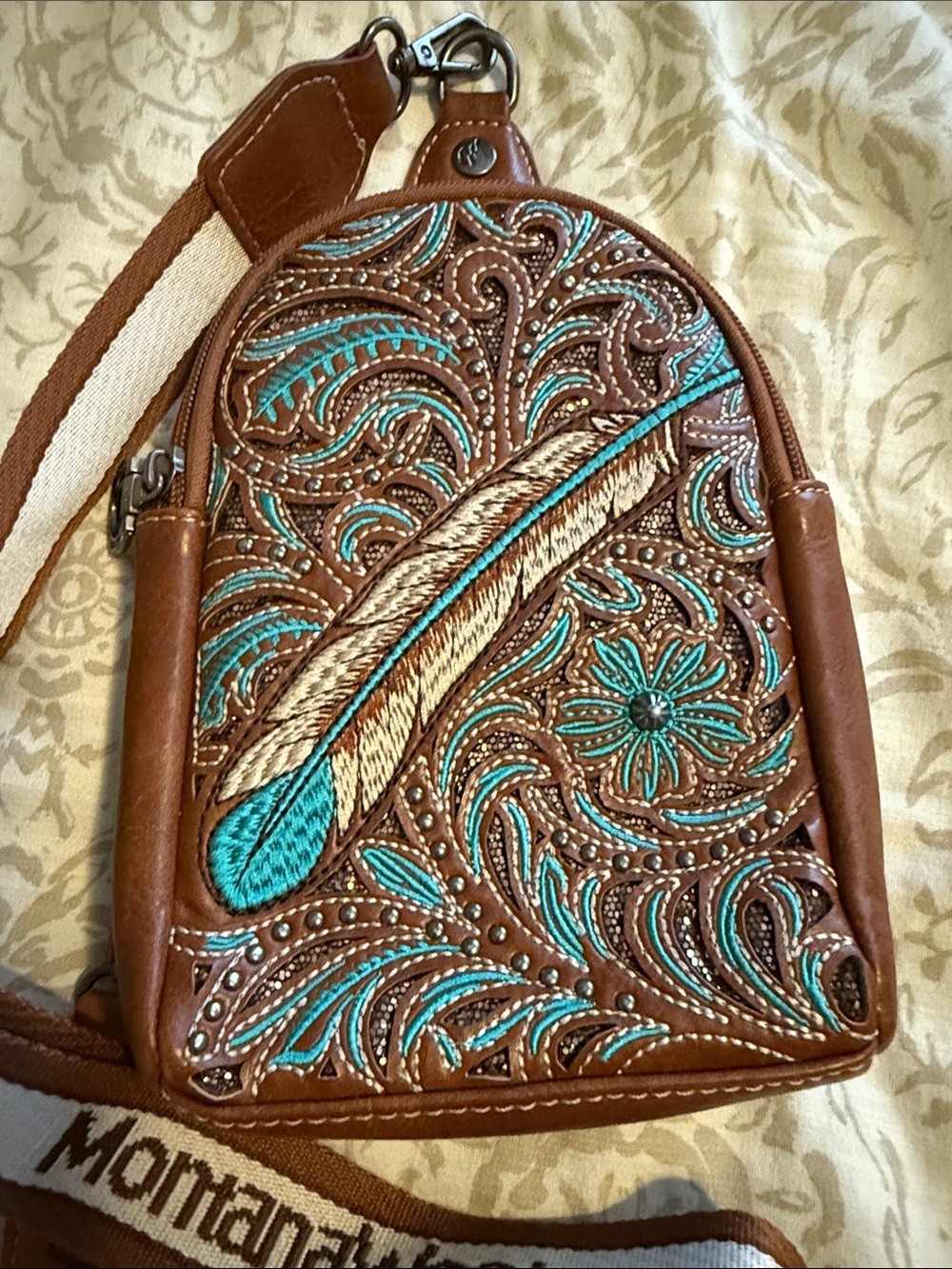 Montana West Embroidered
Feather Cut-Out Floral Sling Bag - Brown and Torquoise